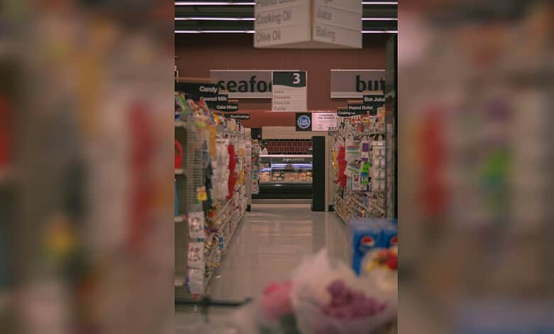 Supermarket aisle with stocked shelves as UAE assures supply of essential goods.