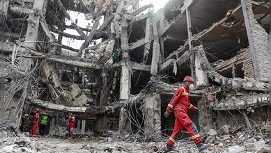 Explosion aftermath in Oman, rescue workers at site.