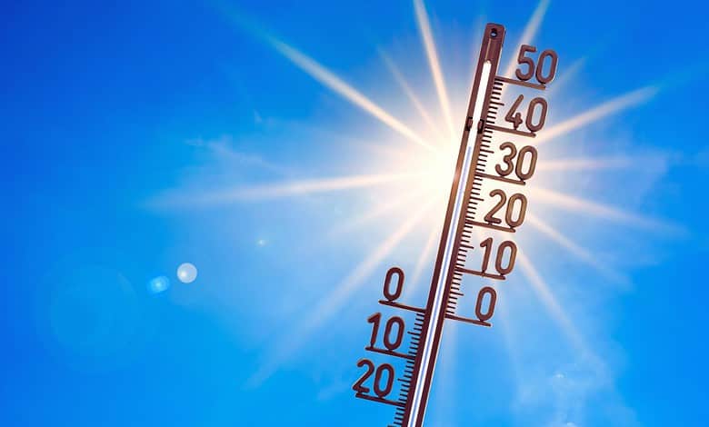 Bright sunny sky with a thermometer showing lower temperatures, symbolising relief from heat in Telangana.