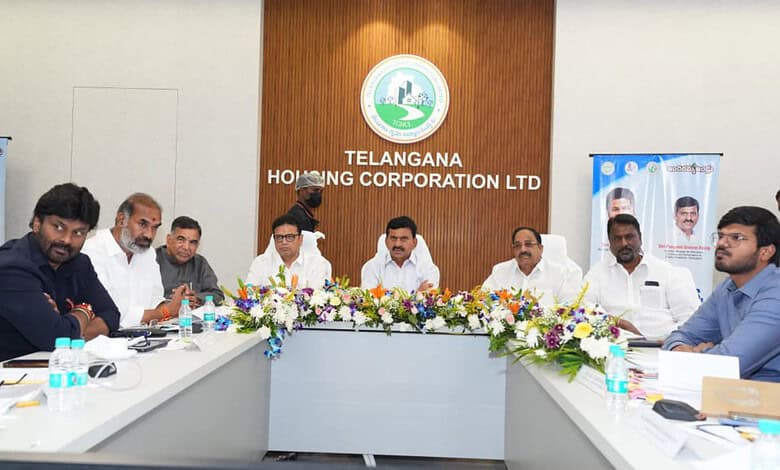Telangana Housing officials review BHK house allocation plans in a meeting.