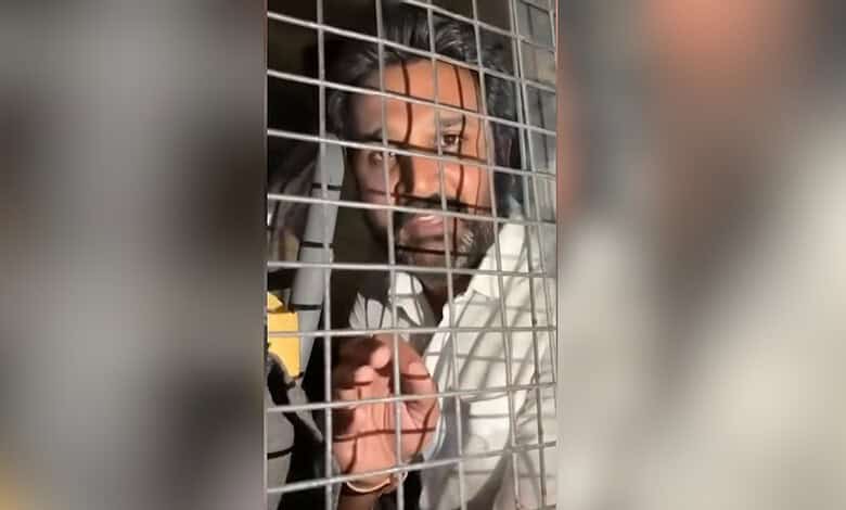 Man behind bars during social media protests in Hyderabad.