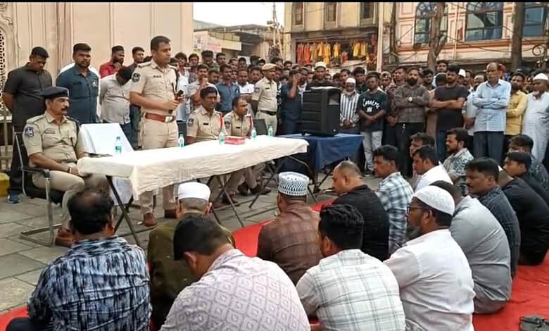 Police officials addressing shopkeepers during a raid on illegal 'hidden tax' practices.