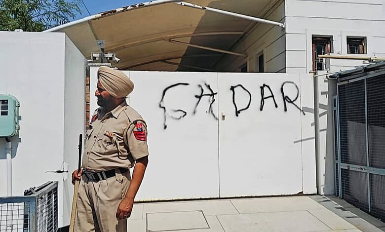 A police official stands guard after AAP workers allegedly wrote 'Gaddar', a traitor, with spray paint on the entrance gate of Rajya Sabha MP Harbhajan Singh, a day after he quit the former party and joined the BJP, in Jalandhar, Punjab, Saturday, April 25.