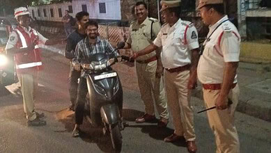 Malkajgiri traffic police stop a motorcyclist for a sobriety check during a crackdown.