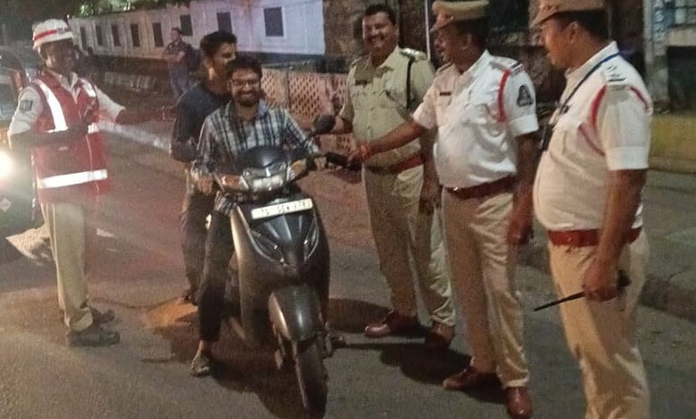 Malkajgiri traffic police stop a motorcyclist for a sobriety check during a crackdown.