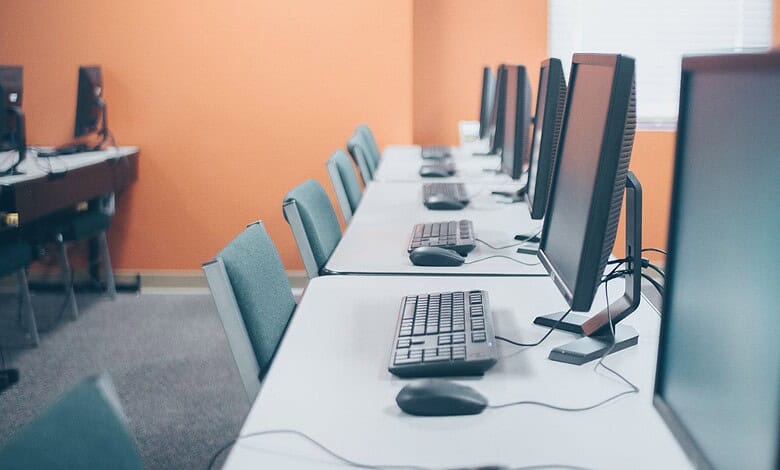 Computer lab with multiple desktops for exam preparation.