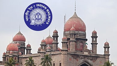 Historic railway building with domes and towers, showcasing Indian architecture.