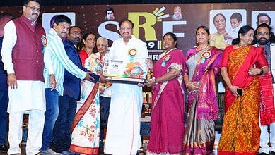 Telangana minister Seethakka receiving Best Service Award from former VP Naidu at an event.