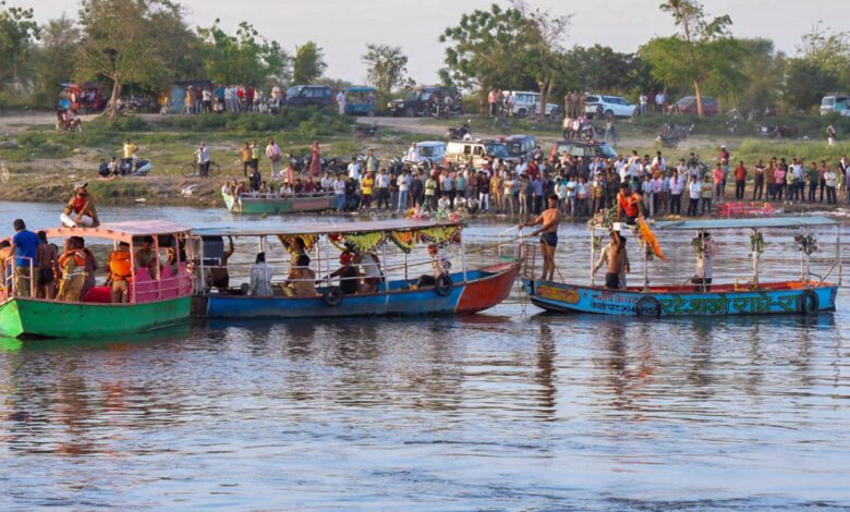 Devotees take a boat ride on the Yamuna