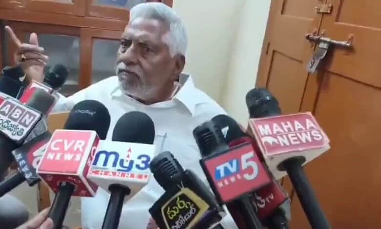 Revanth Reddy surrounded by media microphones during Telangana Congress controversy.