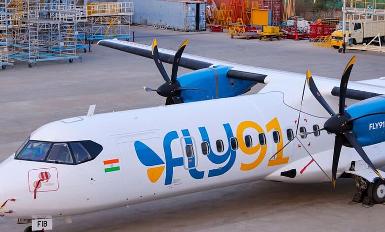 Flydubai plane parked on the tarmac amid airport equipment and cargo.