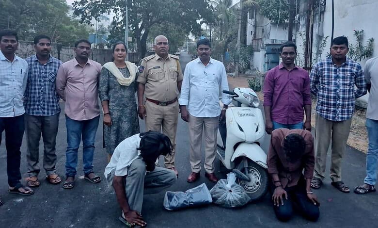 Community members and police officers inspecting seized items on a street.