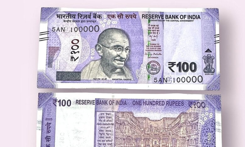 Image of a 100-rupee Indian banknote featuring Mahatma Gandhi.