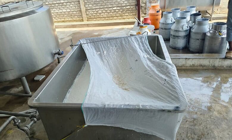 Food adulteration testing with a metal sieve and chemicals in a laboratory setting.