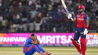 Punjab Kings player celebrating a victory during a cricket match against Delhi Capitals.