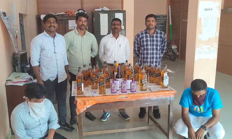 Community members displaying bottles of hand sanitiser at an indoor event for health awareness.