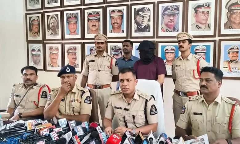 Police officers in Hyderabad hold a press conference after arresting a sales manager involved in a Rs 3 c.