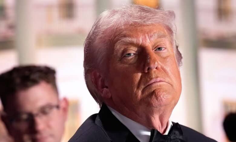 Image of Donald Trump with a serious expression, related to media dinner shooting suspect's statements.