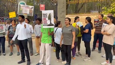 Protesters gather with signs advocating for climate change awareness and environmental protection during.