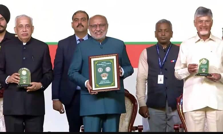 Vice President CP Radhakrishnan reveals a Rs 100 coin at Andhra University along with CM Chandrababu Naidu