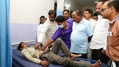 Telangana Minister inspecting victims of crane collapse in hospital with medical staff and officials.