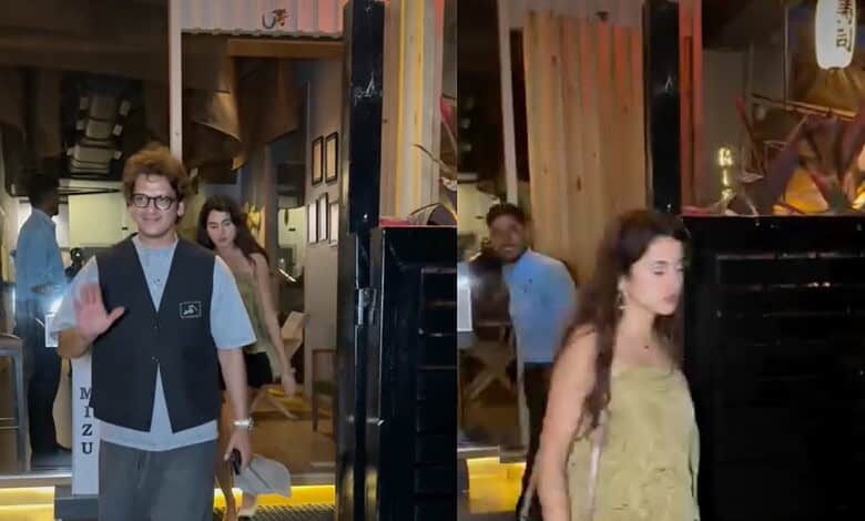 Young woman walking into an event venue with a man waving and smiling in the background.
