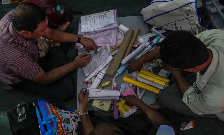 Two men examining documents and posters related to election troublemakers in Calcutta.