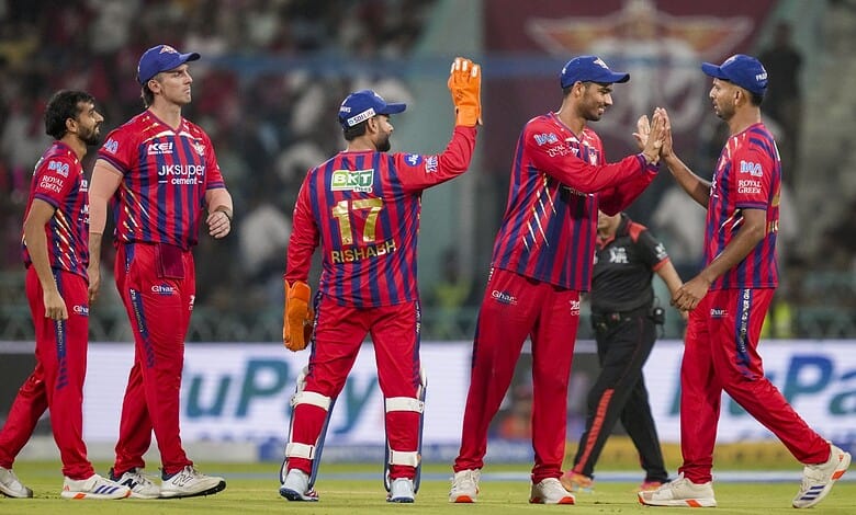 Shami and Mohsin celebrate on the field after a successful bowling effort in cricket match.