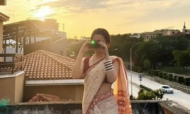 Pakistani actress taking a selfie outdoors, celebrating reaching 20 million followers on Instagram.