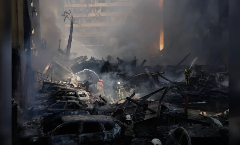 Firefighters battle flames amid heavy smoke after Israeli strikes in Beirut.