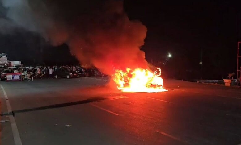 Explosion on the road with fire and smoke at night.