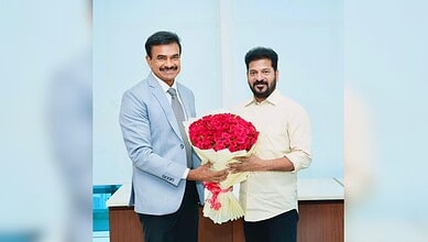 C V Anand presenting a bouquet to Telangana CM Revanth Reddy during official meeting.