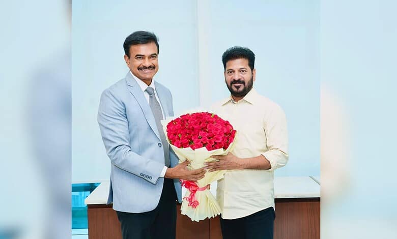 C V Anand presenting a bouquet to Telangana CM Revanth Reddy during official meeting.