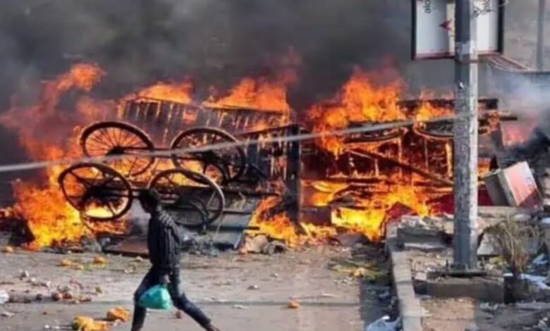 A man walks past a burning structure during the 2020 Delhi riots (File Photo)
