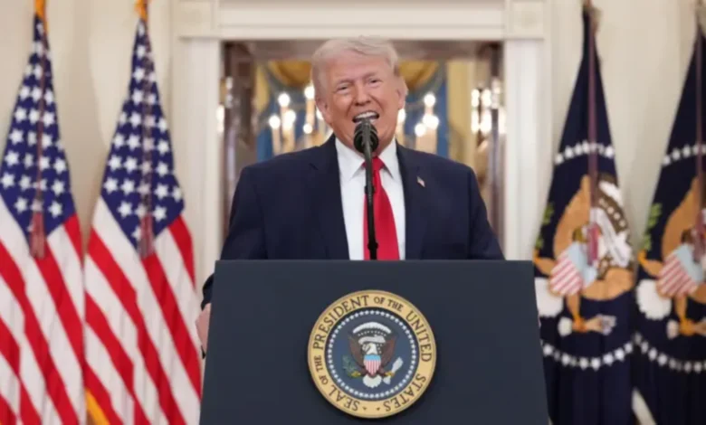 US President Donald Trump delivers a speech at a podium with American flags in the background.
