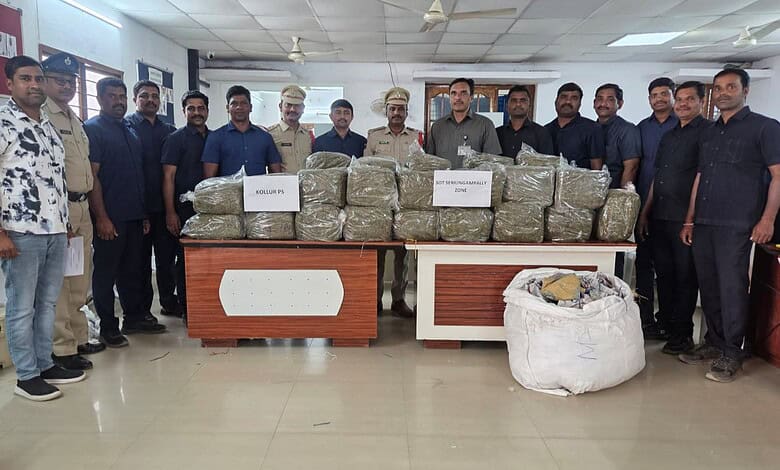 Police officials and officers display confiscated drugs on a table during a press conference.
