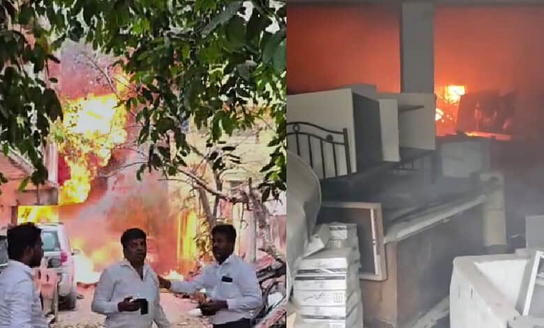 Fire erupts at Mahindra service centre in Hyderabad, with thick smoke and flames visible, causing damage.