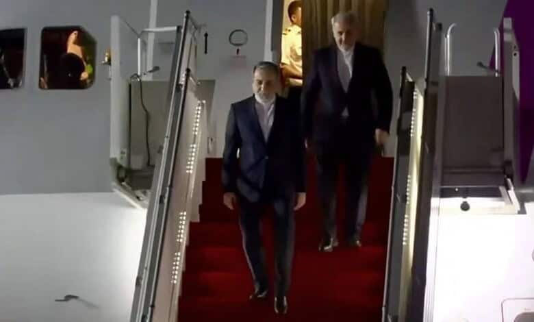 Iranian Foreign Minister Araghchi walking down the stairs in formal attire in Islamabad.
