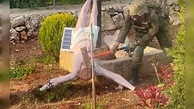 Israeli soldier smashing a Jesus Christ statue with a sledgehammer in southern Lebanon