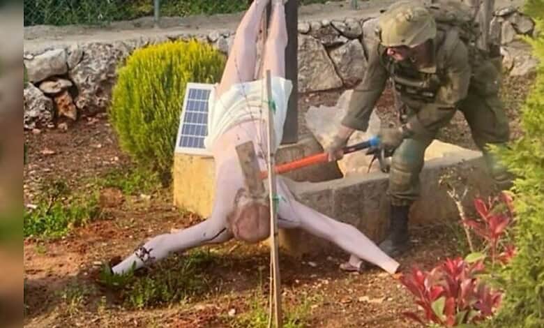 Israeli soldier smashing a Jesus Christ statue with a sledgehammer in southern Lebanon