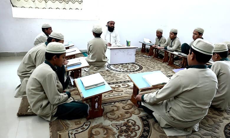 Young students studying Quran in a classroom setting.