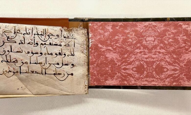 Rare handwritten Quran manuscript with aged pages and Arabic calligraphy, displayed in Makkah.