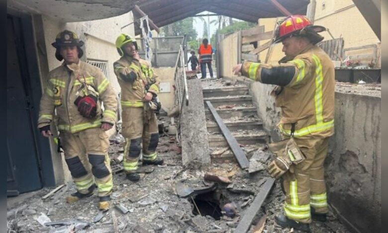 Damage in Rosh Haayin after Iranian missile strike, firefighters inspect debris.