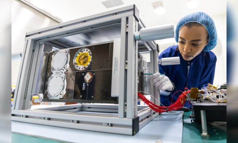Engineer works on Shams satellite assembly in Saudi laboratory.