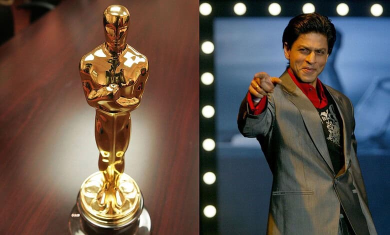 Shah Rukh Khan reacts as he receives an Oscar honour, standing confidently on stage.