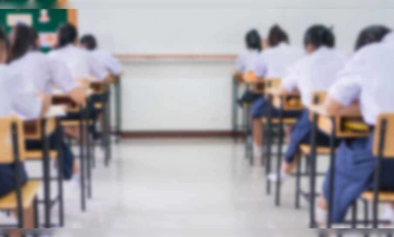 Students seated in a classroom taking an examination.