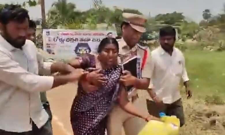 Woman attempting suicide over housing issue in Suryapet, surrounded by helpers.