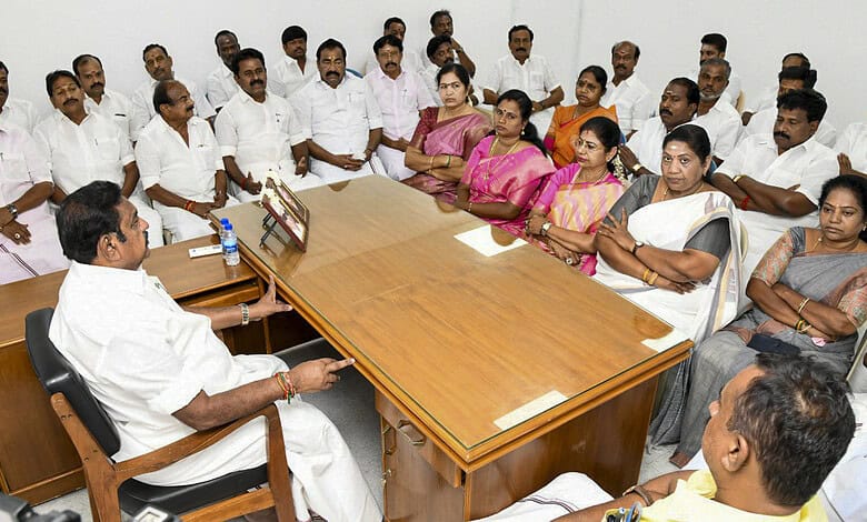 Group of political leaders and observers in a meeting room discussing government formation.