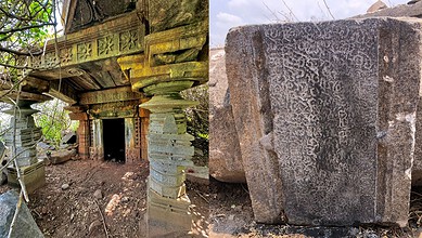Ruins of a historic Shiva temple in Telangana, showcasing stone carvings and damaged structure.