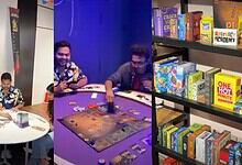 Engaging group playing board game in a modern gaming room with shelves of board games and books.